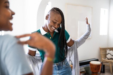 Signs including "Defend Black Voices and "Black Lives Matter" are held up at a demonstration